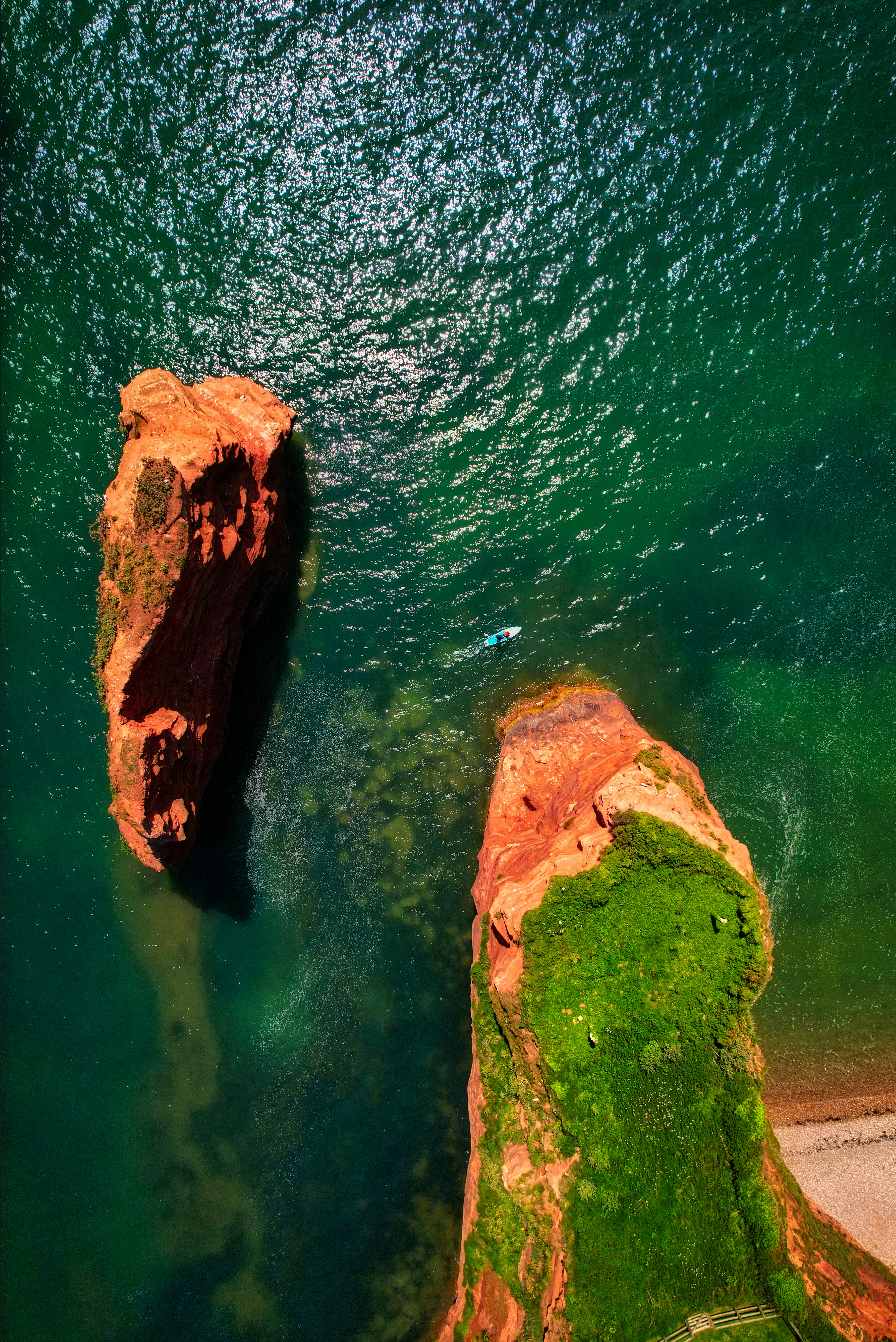 two large rocks sticking out of a body of water