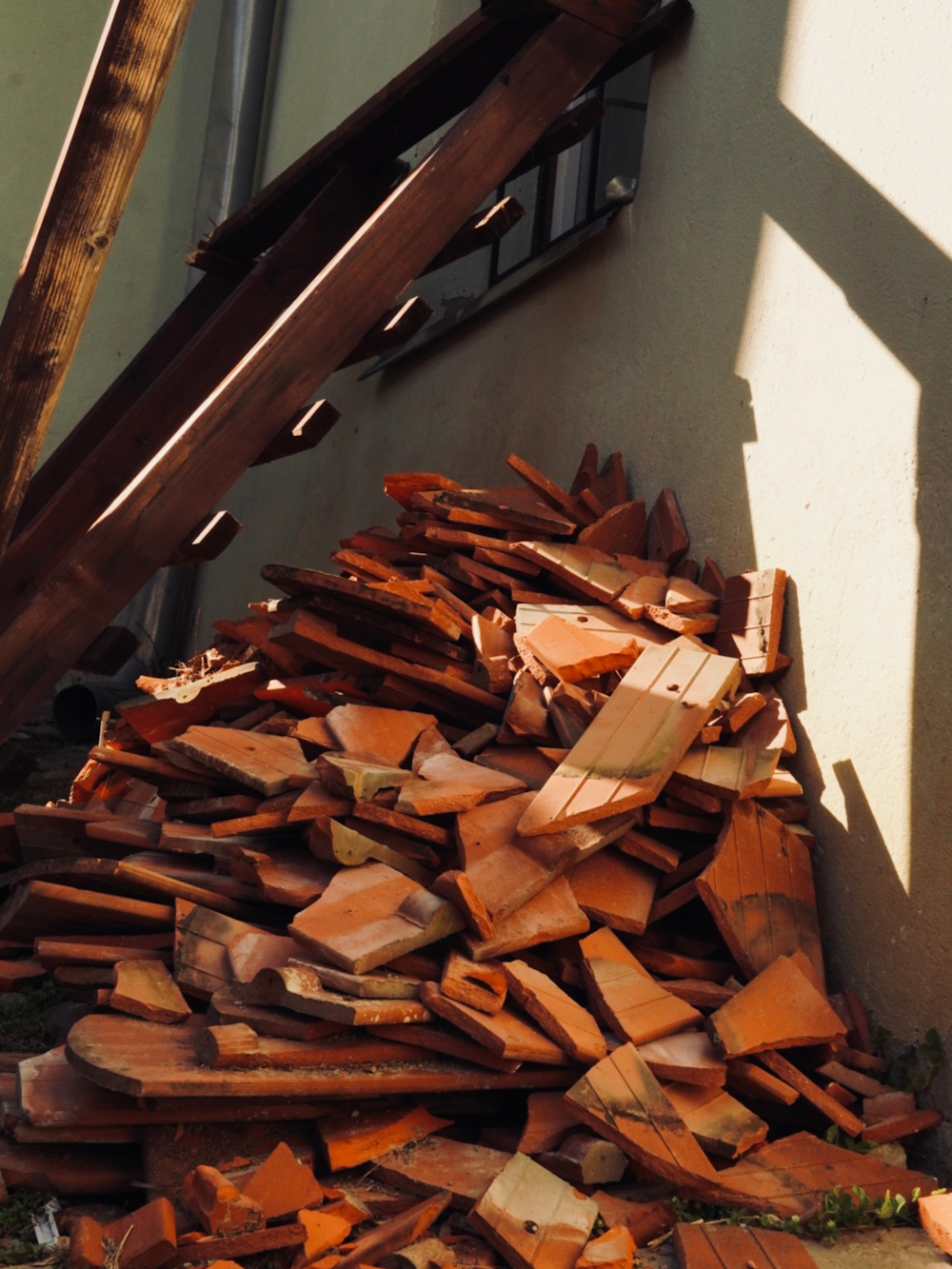 a pile of wood sitting next to a building