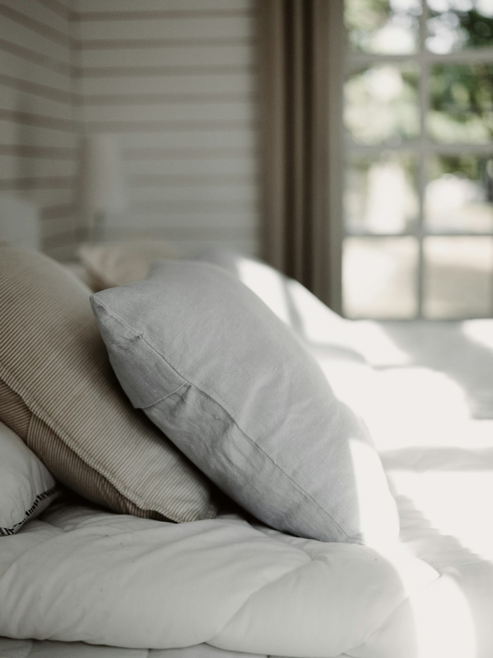 a close up of pillows on a bed
