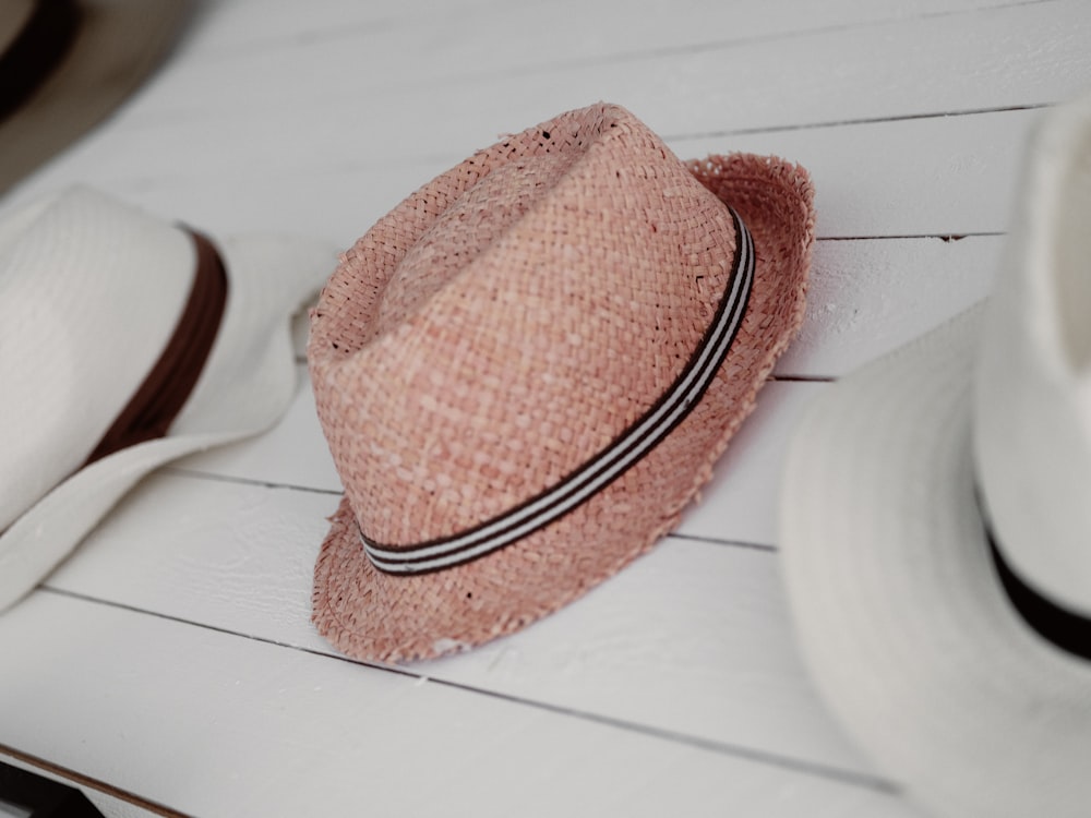 a pink hat sitting on top of a white table