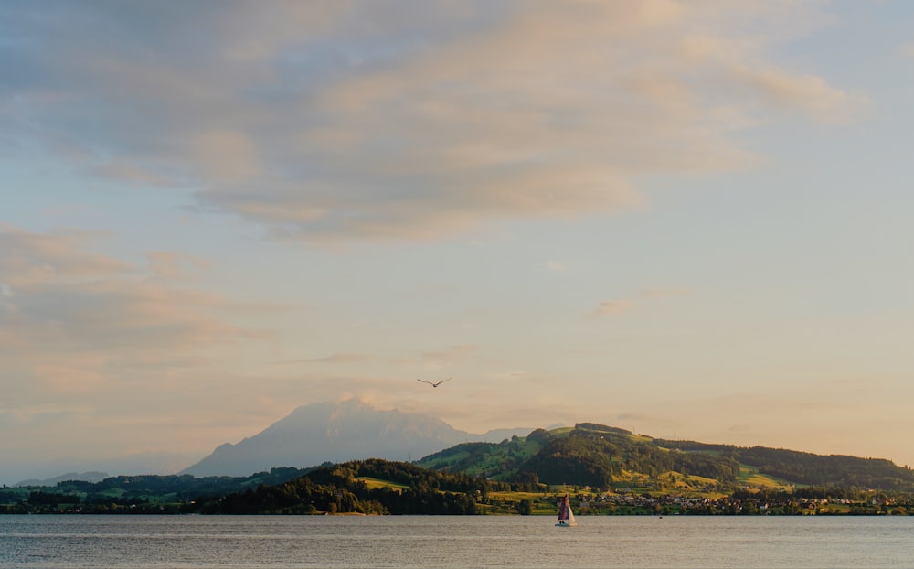 a large body of water with a mountain in the background