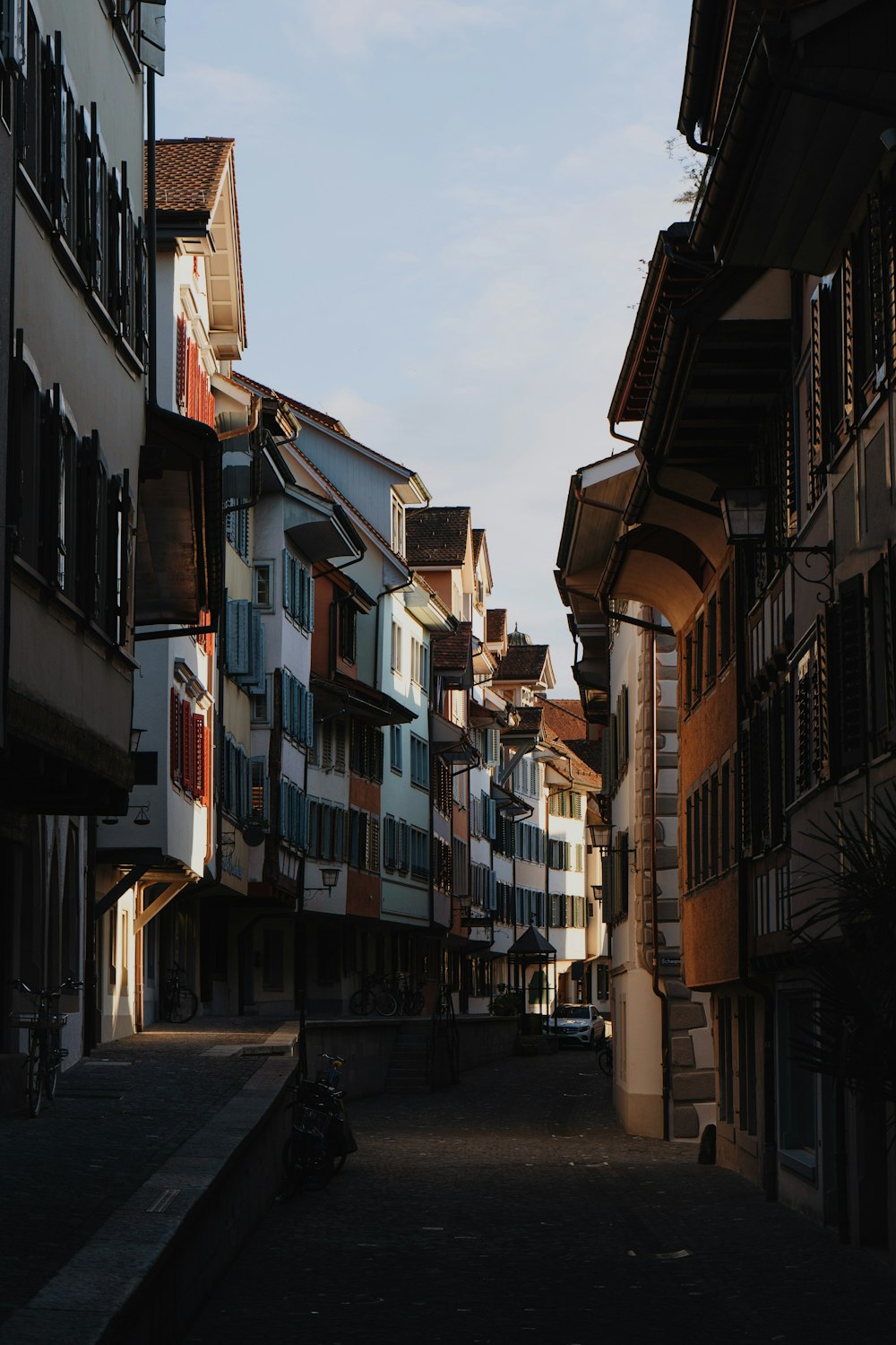 a narrow street with several buildings on both sides