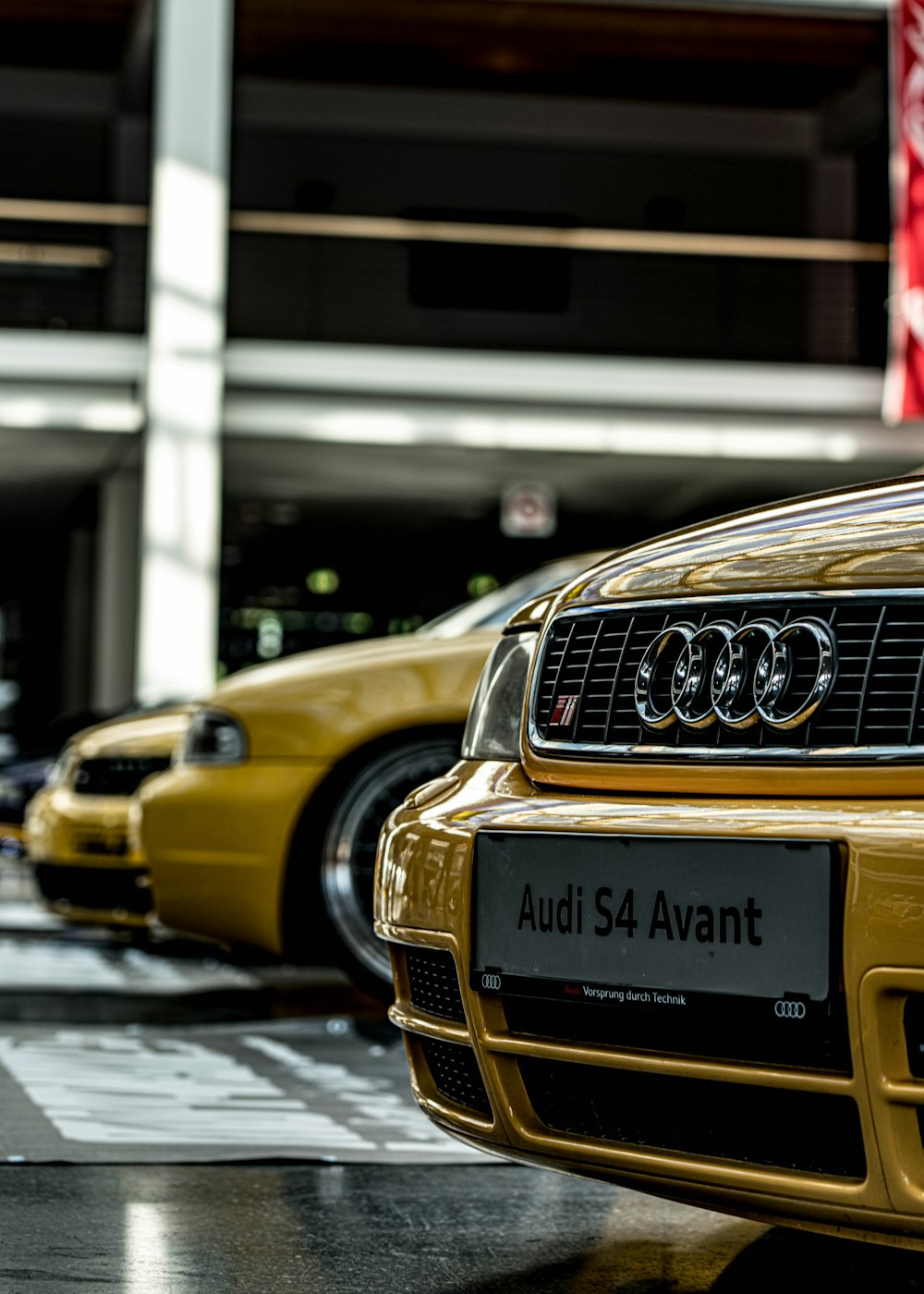 a row of yellow cars parked next to each other