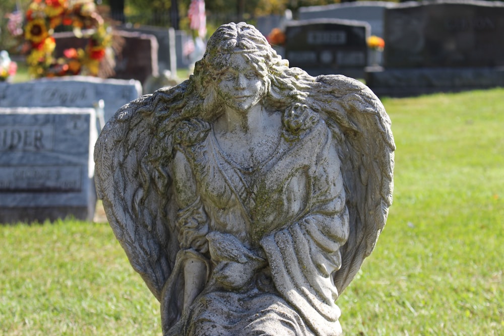 a statue of an angel in a cemetery