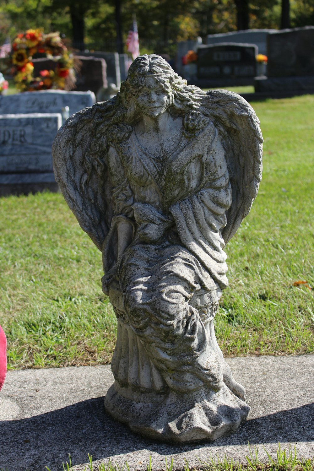 a statue of an angel in a cemetery