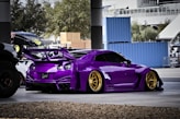 a purple sports car parked in a parking lot