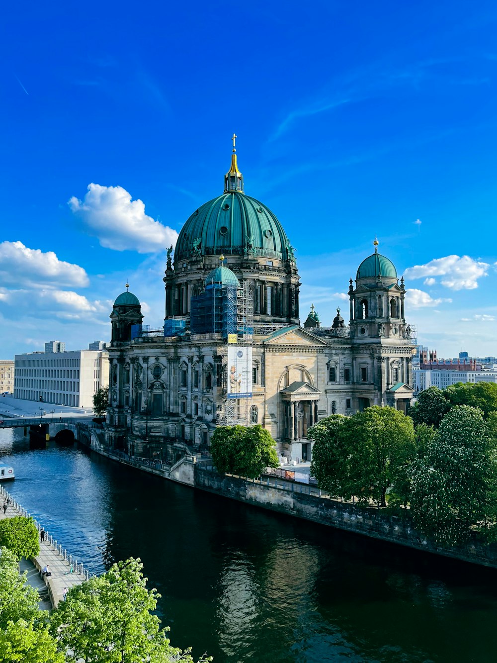 a large building sitting next to a river