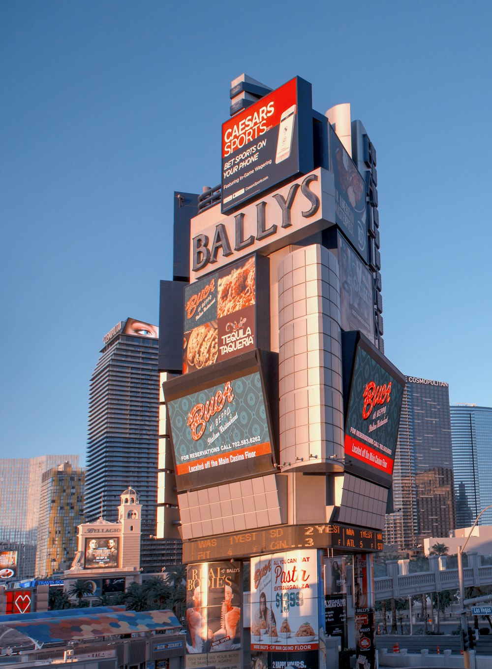 a tall building with advertisements on the side of it