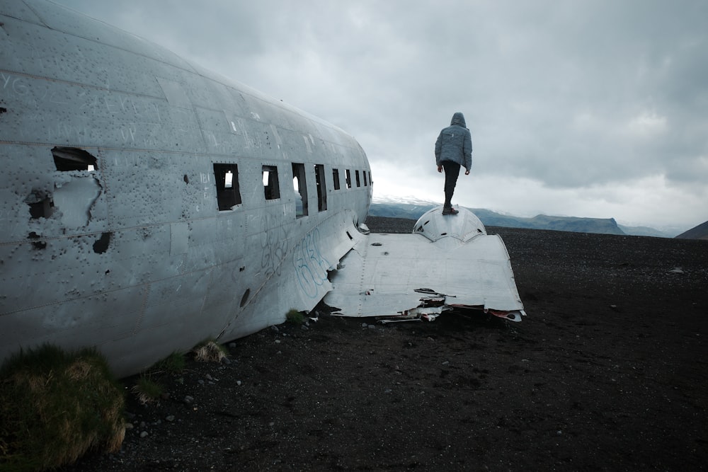 a person standing on the side of an airplane