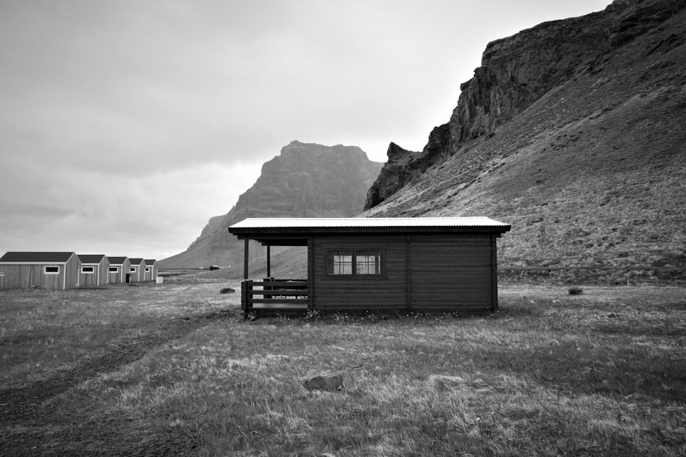 a black and white photo of a small cabin