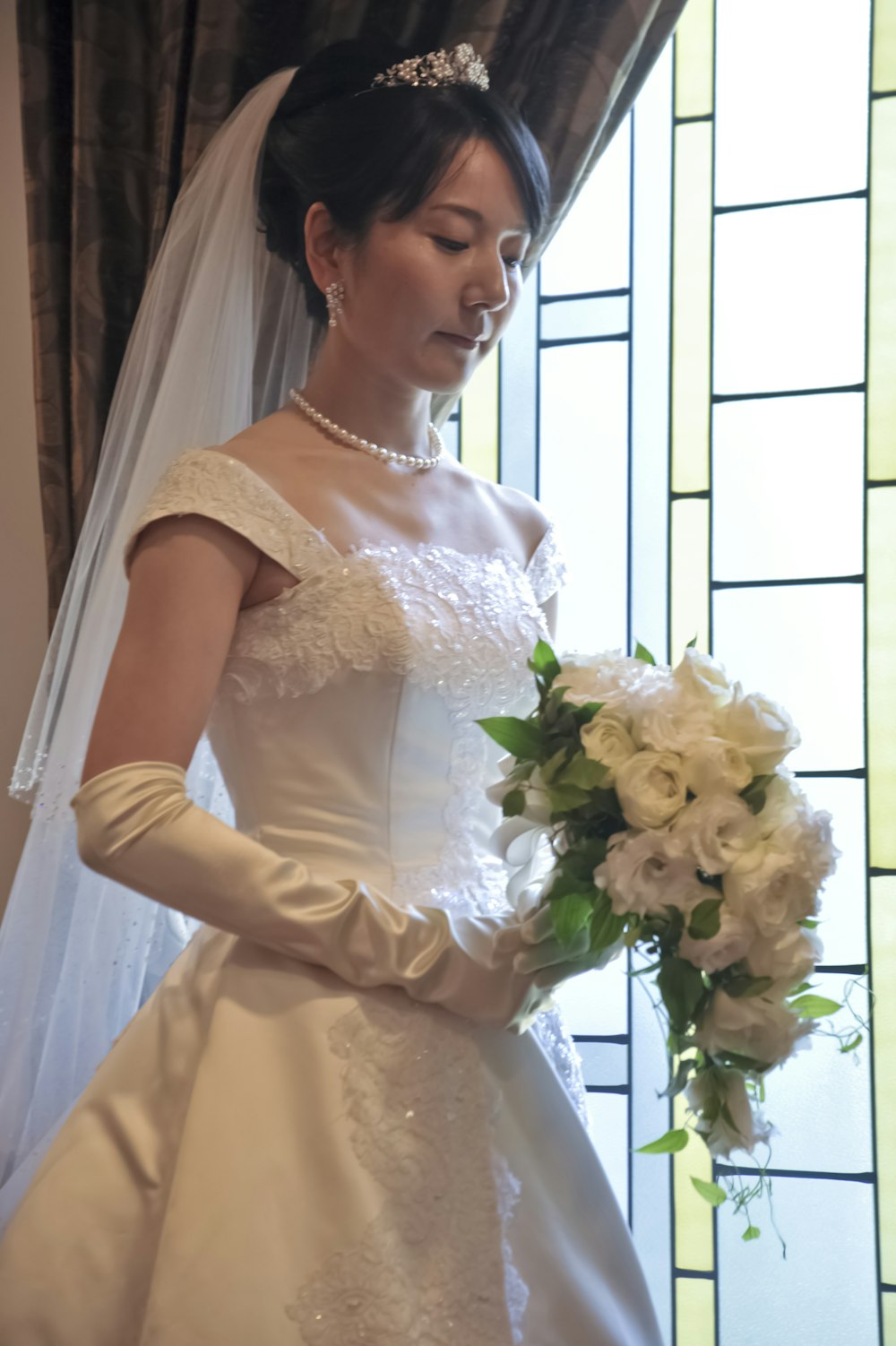 a woman in a wedding dress holding a bouquet of flowers