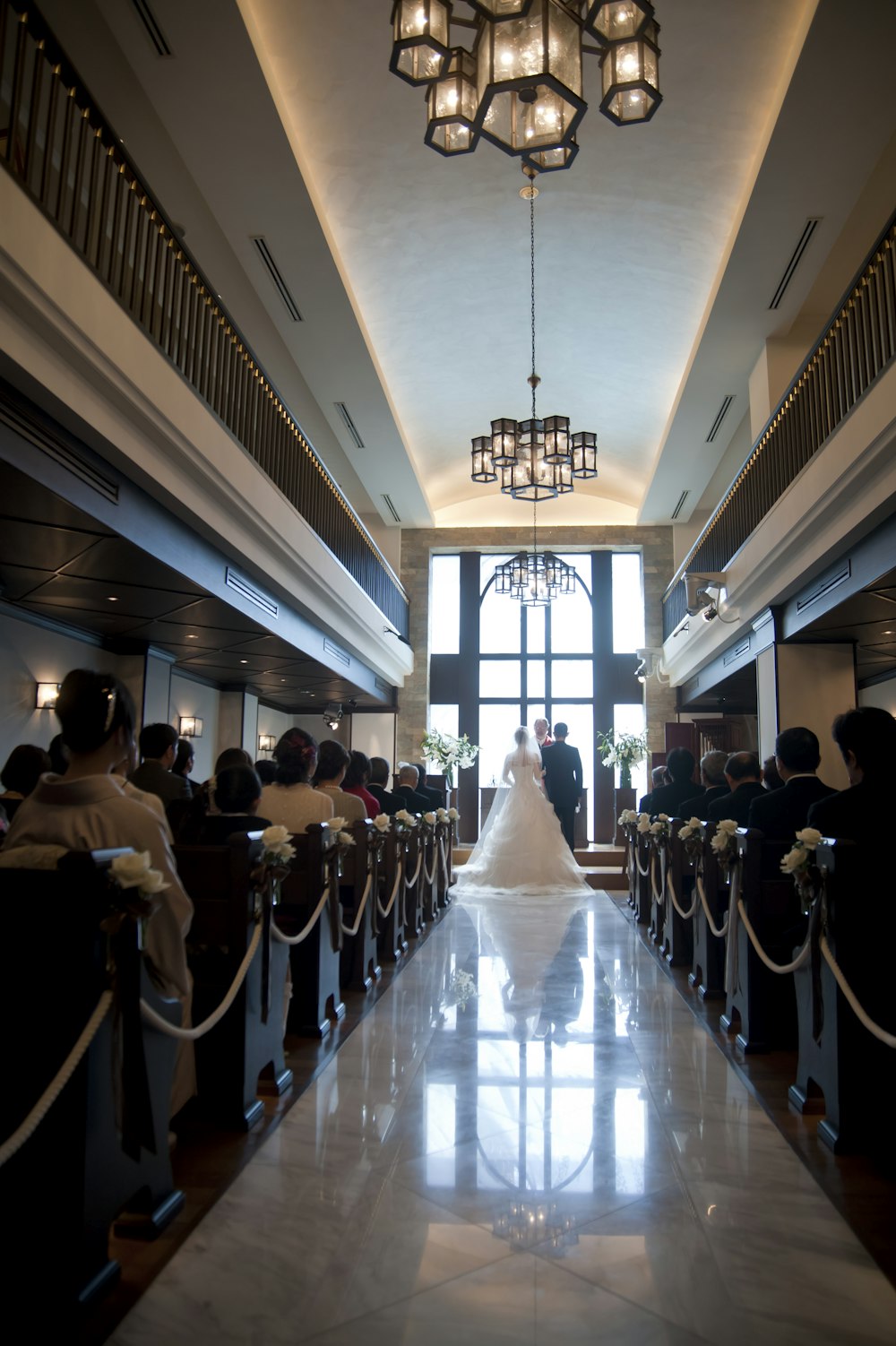 a bride and groom walking down the aisle of a church