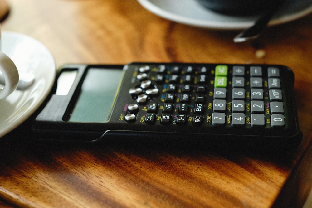 a calculator sitting on top of a wooden table