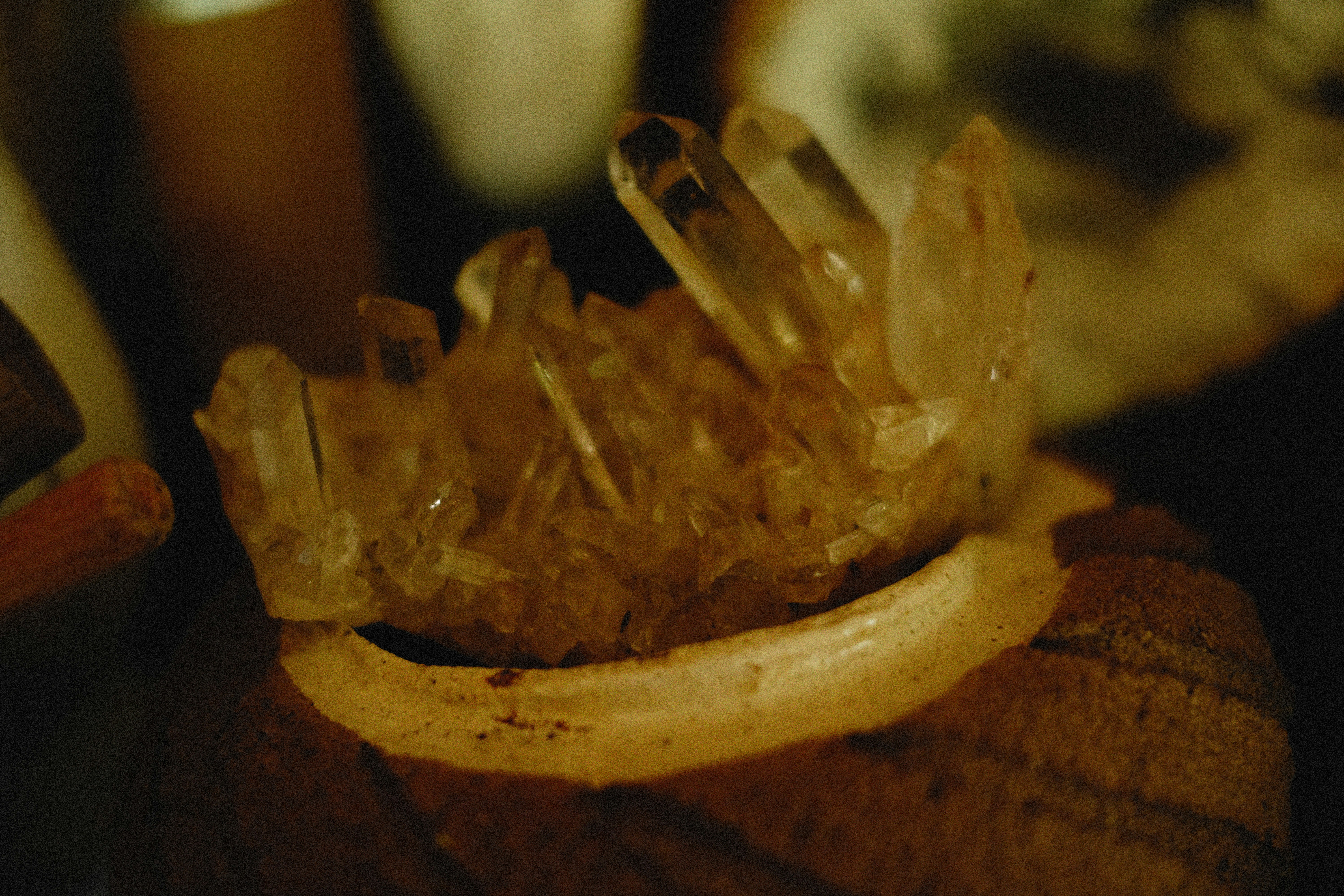 A serene photo of a crystal cluster glowing softly in natural light on a wooden table.