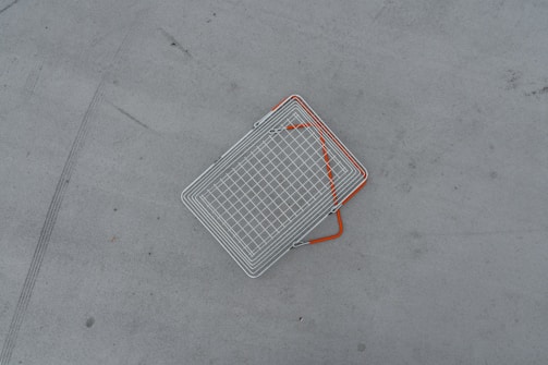 a metal object laying on the ground with orange lines