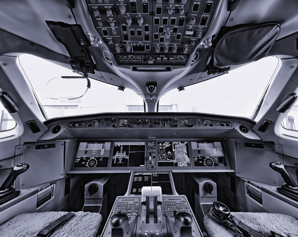 the inside of an airplane with multiple controls