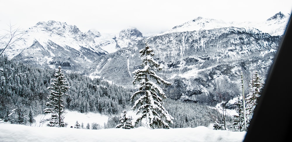 a view of a snowy mountain range from a window