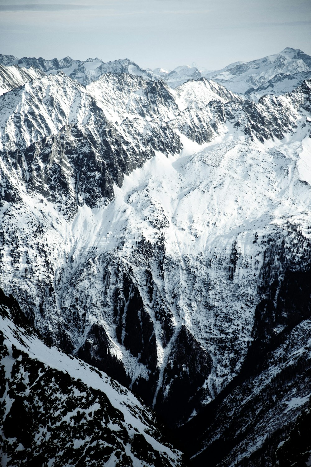 a mountain range covered in snow in the mountains