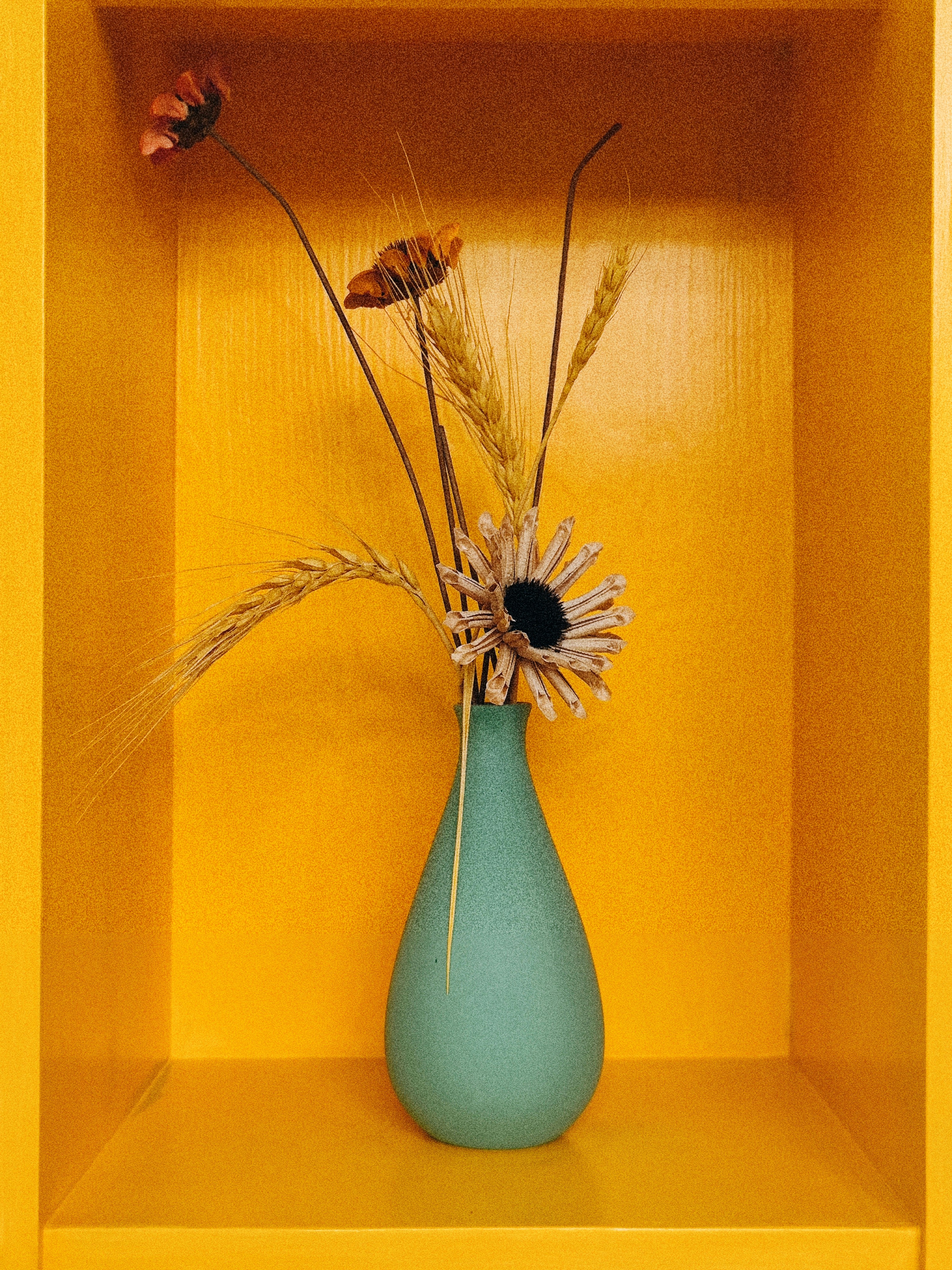 a blue vase with some flowers in it