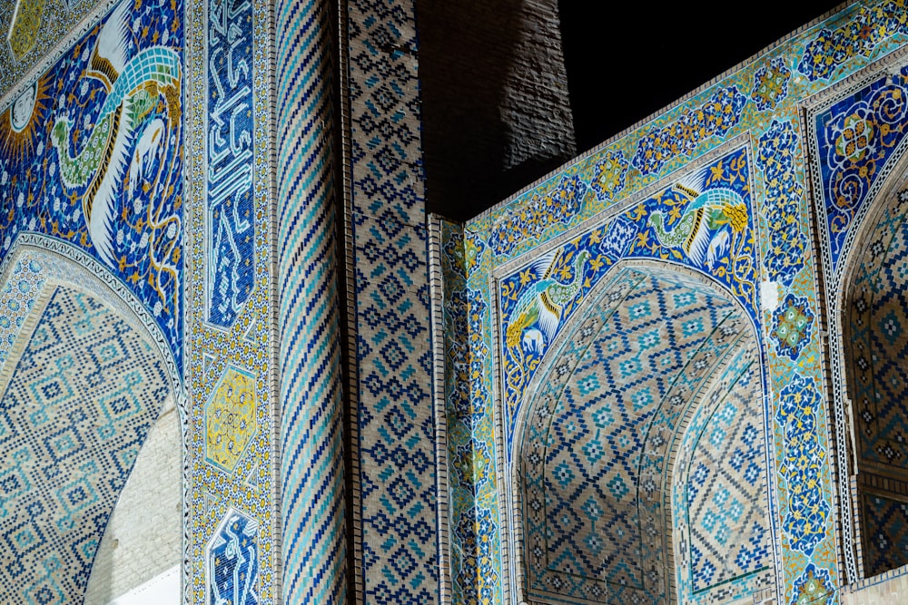 a close up of a building with blue and green tiles