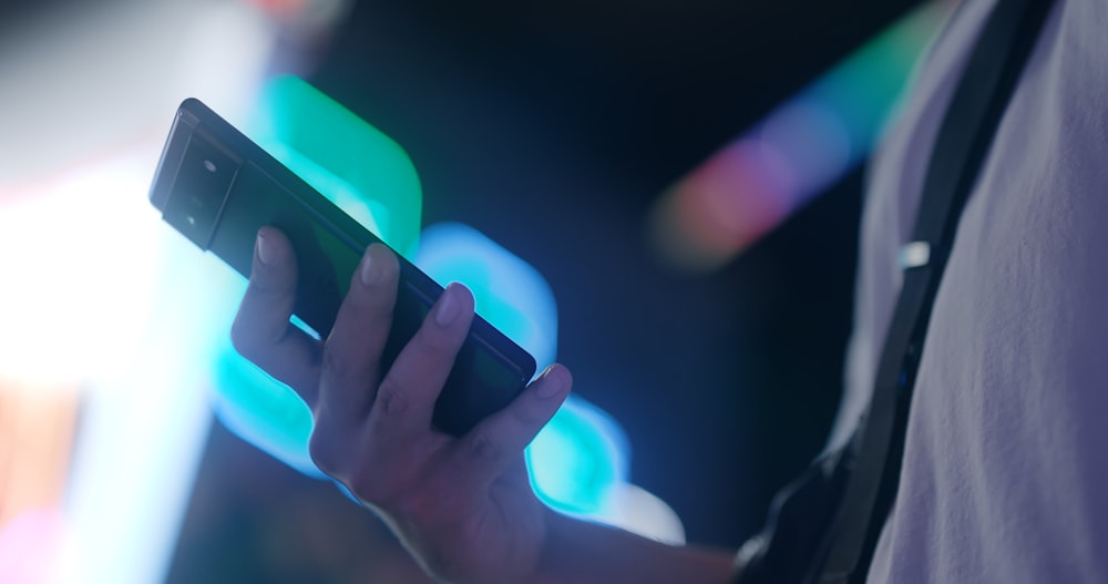 a close up of a person holding a cell phone