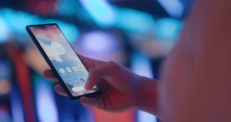 a person holding a cell phone in their hand