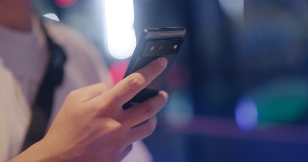 a close up of a person holding a cell phone