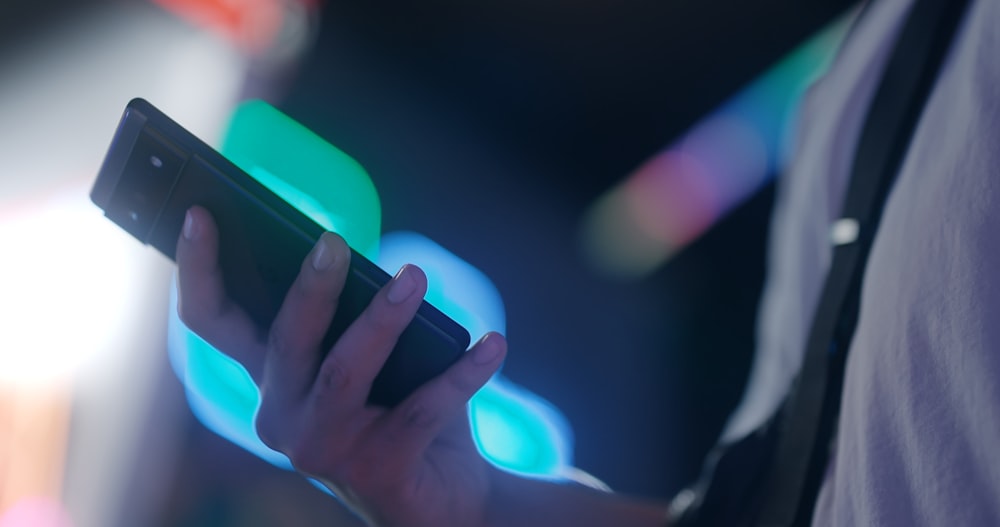 a close up of a person holding a cell phone