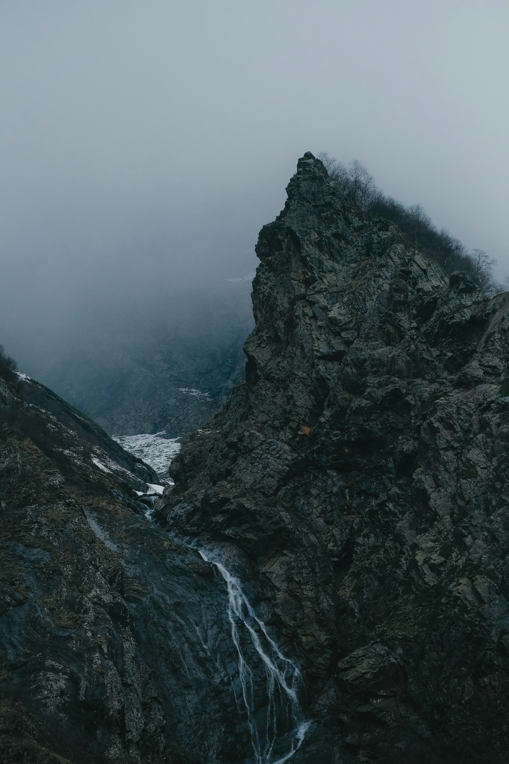 a mountain with a waterfall in the middle of it