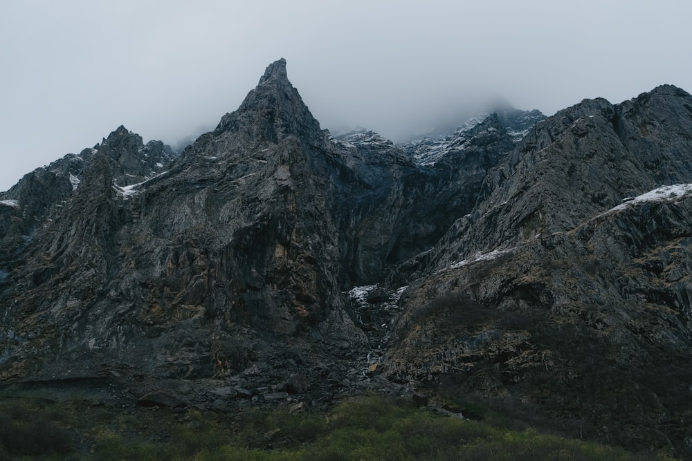 a very tall mountain with some snow on it