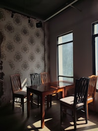 a dining room with a table and four chairs