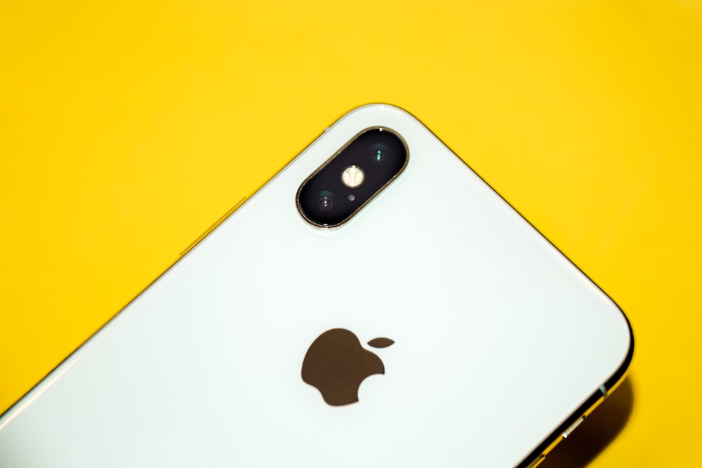 a close up of an iphone on a yellow background