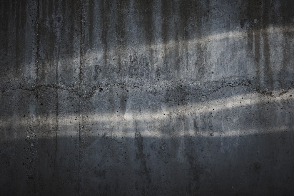 a concrete wall with a shadow cast on it