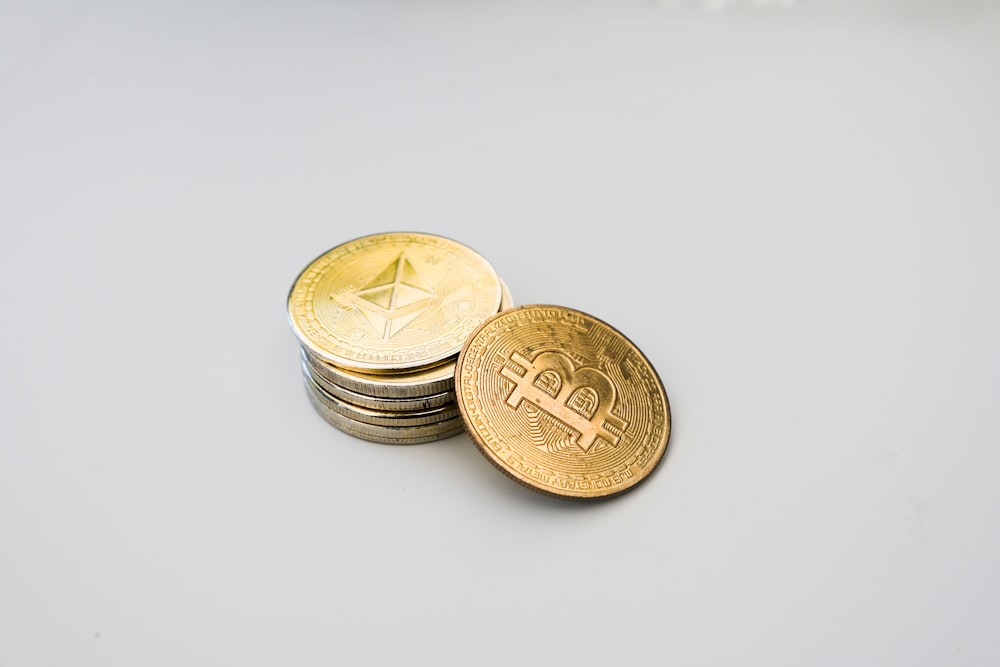 a stack of coins sitting on top of a white table