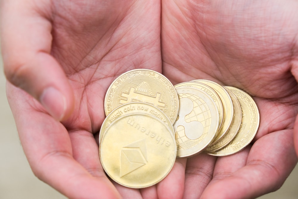 a person holding a handful of coins in their hands