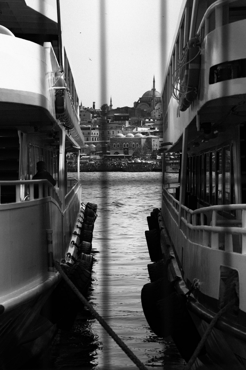a black and white photo of some boats in the water