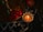 A burning candle in an ornate holder sits next to a brass tray adorned with red and yellow flower petals. The setting is dimly lit, creating a warm and serene ambiance.