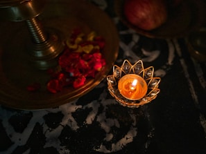 Elegant soy wax candle glowing softly on a black and gold tray