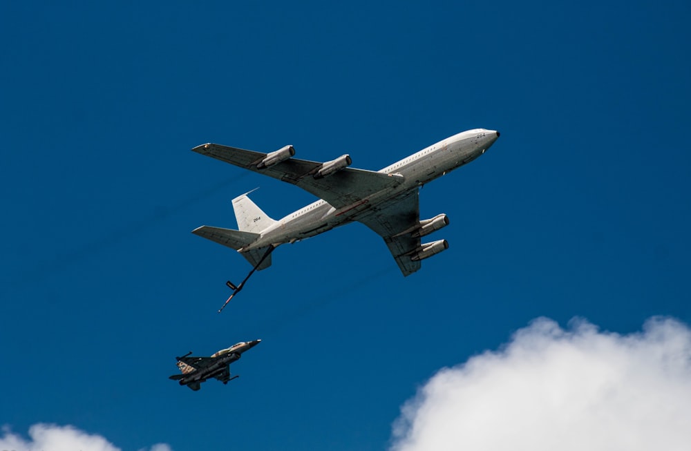 a large jetliner flying through a blue cloudy sky