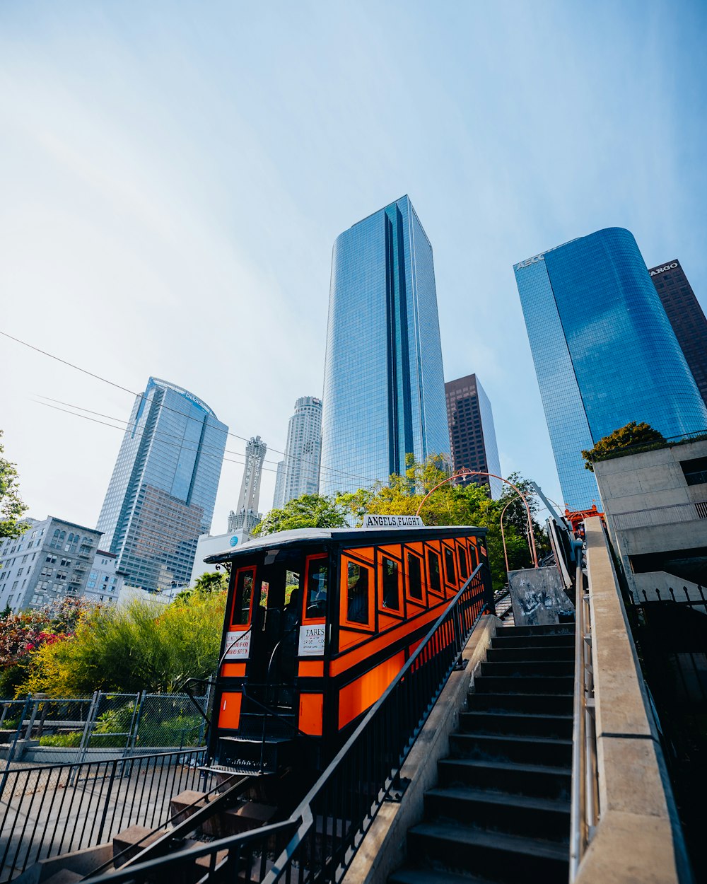 a red and black train going down a set of stairs