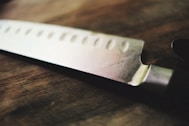a close up of a knife on a wooden table