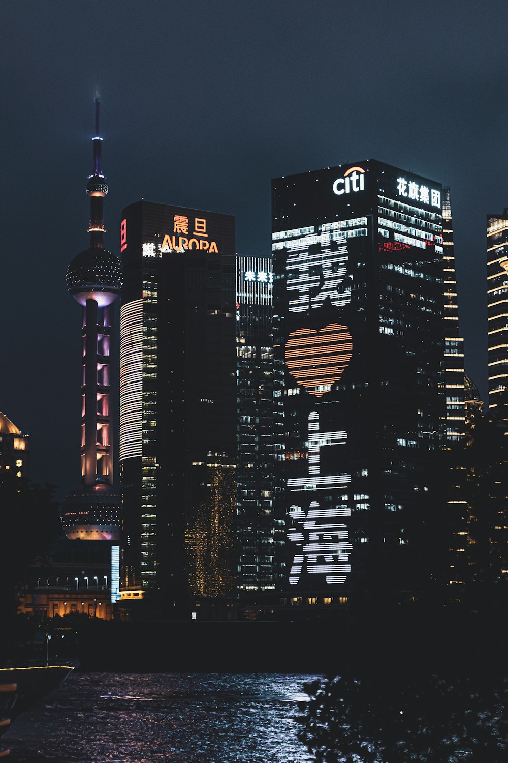 a city skyline at night with skyscrapers lit up