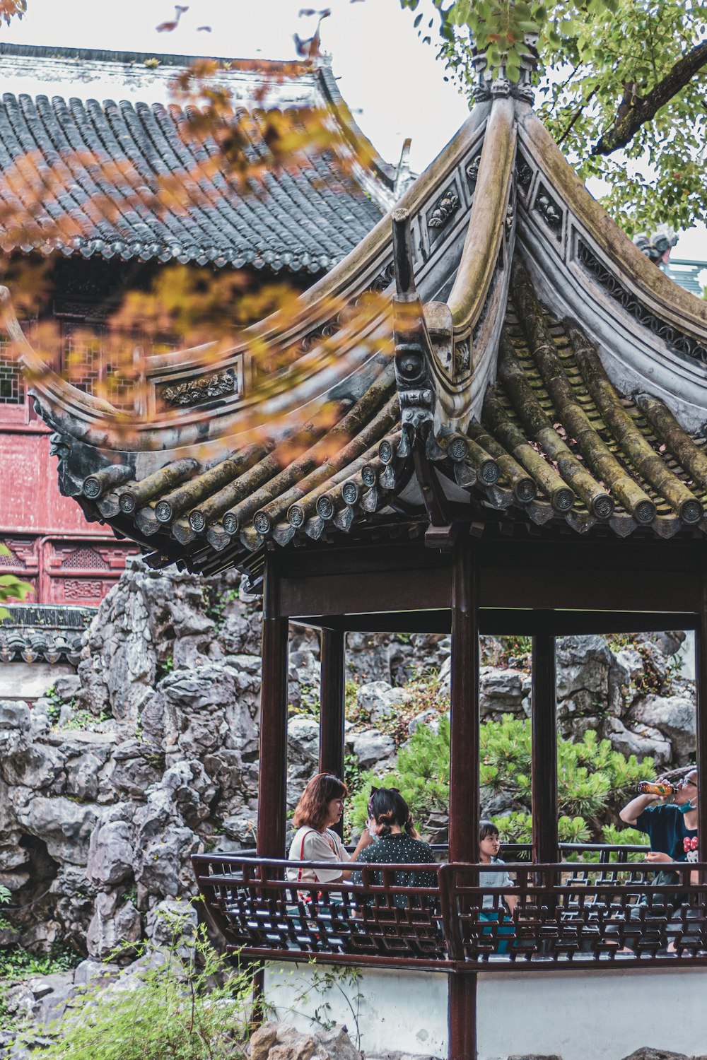 a group of people standing around a pavilion