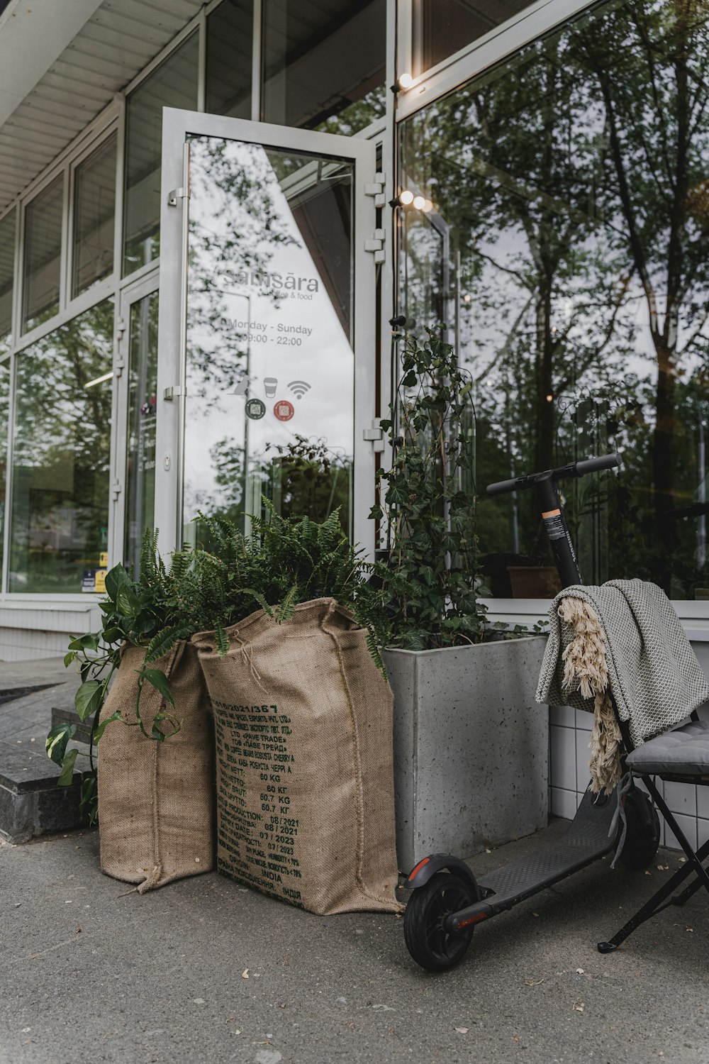 a scooter parked in front of a building with bags on the ground