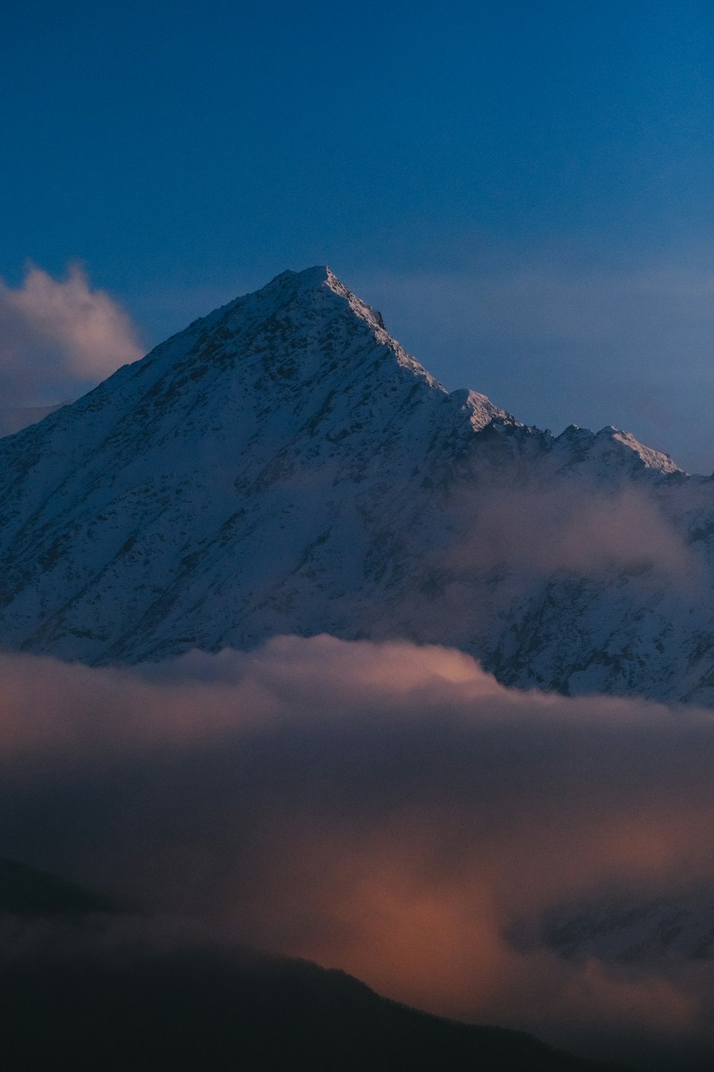 a mountain with clouds around it