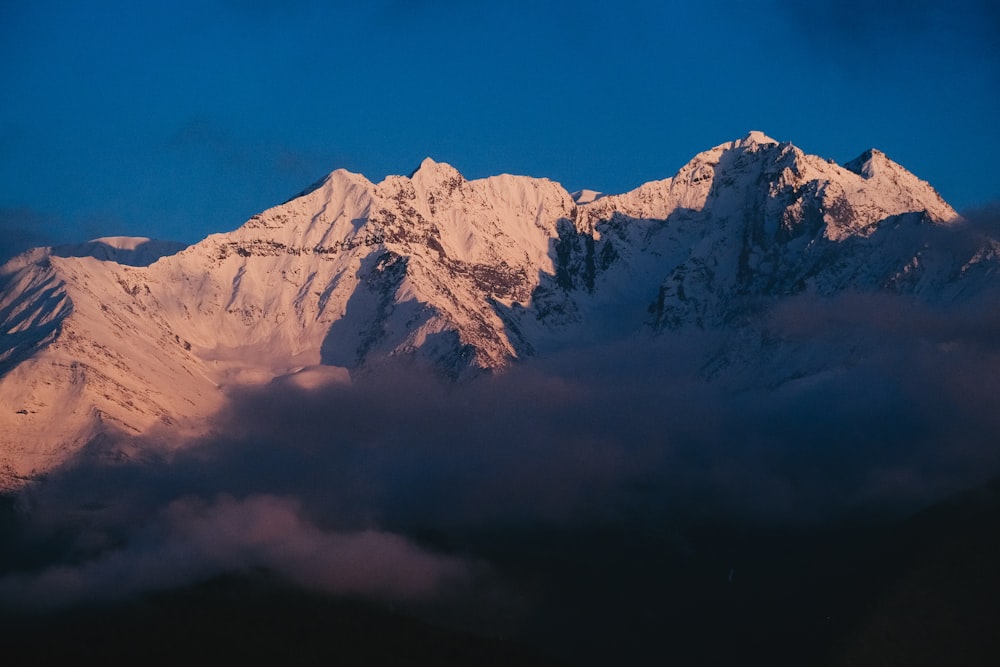 a view of a snow covered mountain from a plane