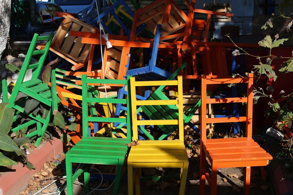 a pile of colorful chairs sitting next to each other