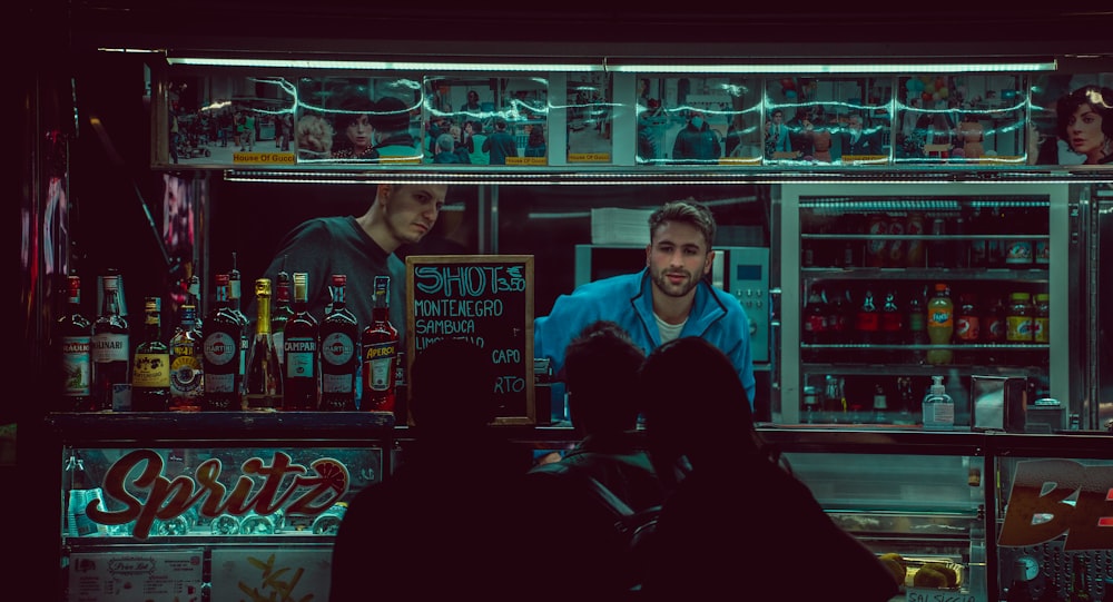 a group of people standing around a bar