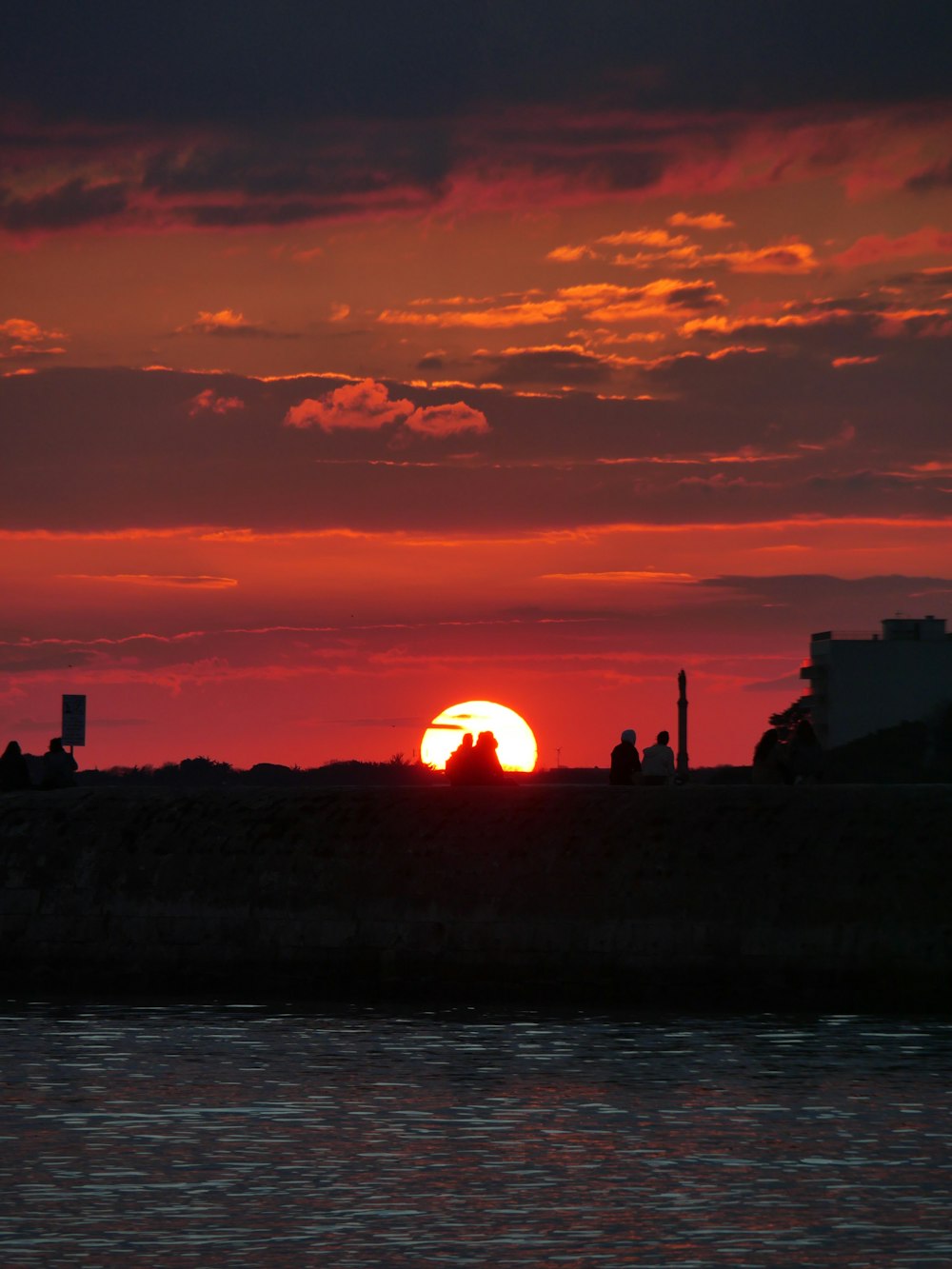 the sun is setting over a body of water