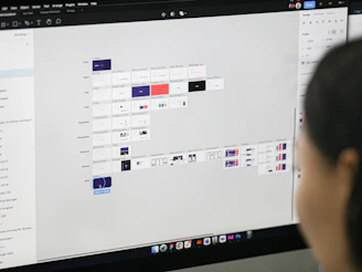 a woman is looking at a computer screen